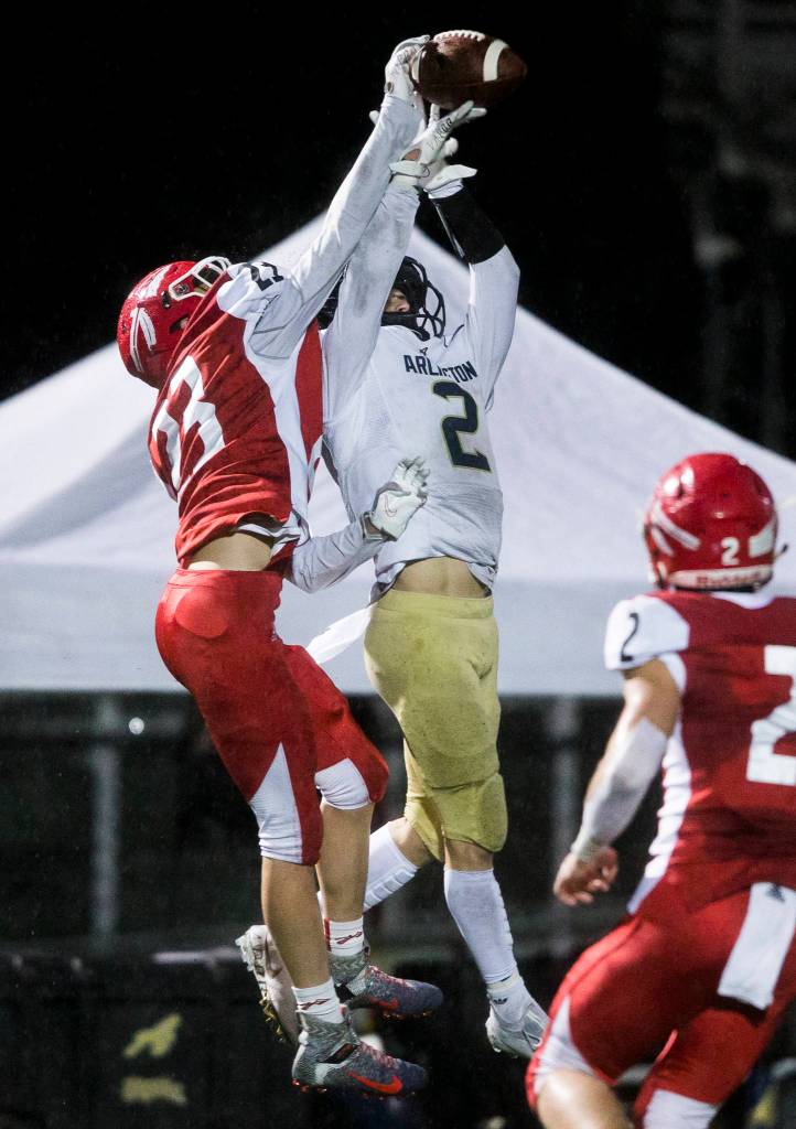 Marysville-Pilchucks Jaxon Petermeyer blocks a pass to Arlingtons Levi Young during the game on Friday, March 19, 2021 in Marysville, Wa. (Olivia Vanni / The Herald)