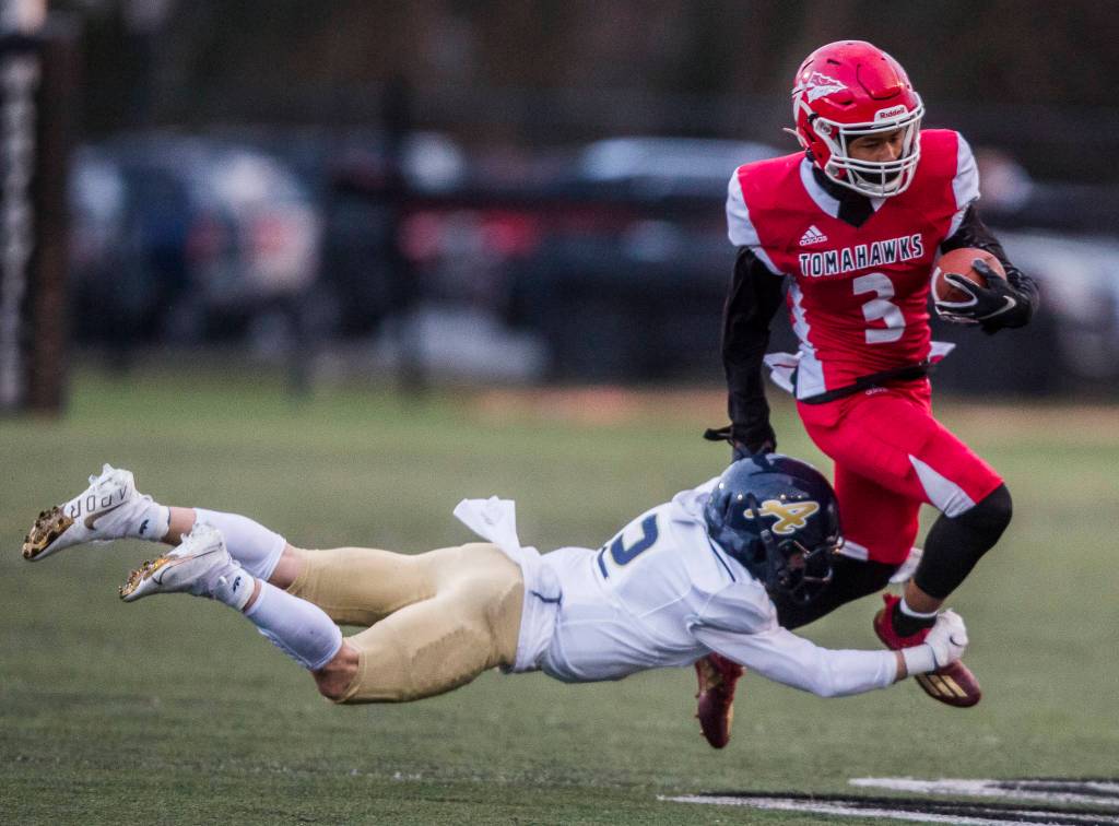 Marysville-Pilchucks Gaylen Gray is tackled by Arlingtons Levi Young during the game on Friday, March 19, 2021 in Marysville, Wa. (Olivia Vanni / The Herald)