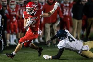 Marysville-Pilchuck's Jordan Velasquez dodges a tackle by Arlington's Parker Duskin during the game on Friday, March 19, 2021 in Marysville, Wa. (Olivia Vanni / The Herald)