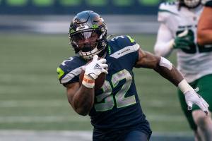 Seattle Seahawks running back Chris Carson runs with the during the second half of an NFL football game against the New York Jets, Sunday, Dec. 13, 2020, in Seattle. The Seahawks won 40-3. (AP Photo/Stephen Brashear)