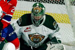Silvertips' Dylan Anderson and Dustin Wolf defending a shot attempt by Chiefs' Reed Jacobson Saturday night at Angel of the Winds Arena in Everett on March 20, 2021. Everett won 2-0. (Kevin Clark / The Herald)