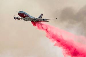 The Global Supertanker drops retardant while battling the Glass Fire in Napa County, Calif., on Sunday, Sept. 27, 2020. (AP Photo/Noah Berger)