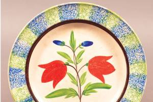 Dinnerware was made with overall spatter or sponged decoration or with a spatter or sponged border and center design. Both are popular vintage collectibles. Price is determined by the condition and the skill of the decorator. Center designs can be a single flower or a scene of rabbits playing baseball. This plate has stylized tulips with a spatter stripe border and sold for $224. (Cowles Syndicate Inc.)