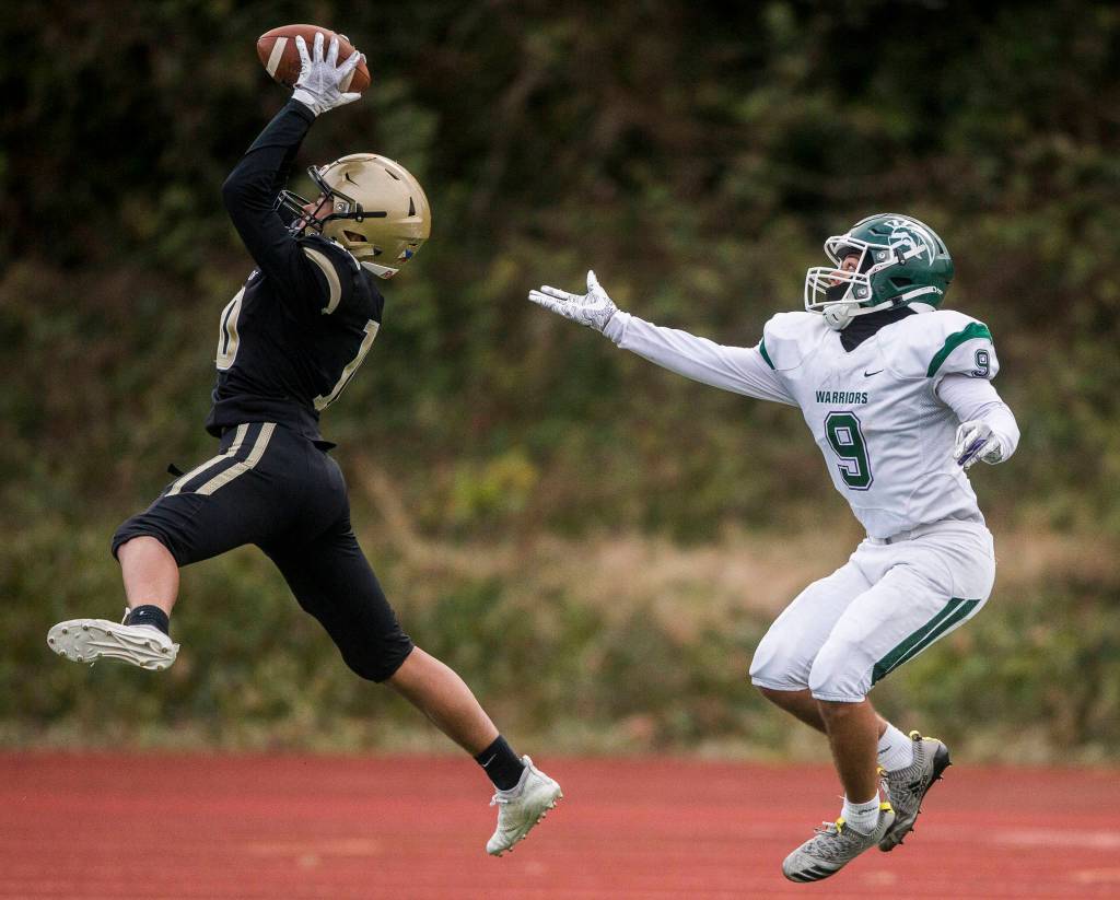 Lynnwoods John Miguel Hurtado intercepts a pass to Edmonds-Woodways Steele Swinton during the game on Friday, March 26, 2021 in Edmonds, Wa. (Olivia Vanni / The Herald)