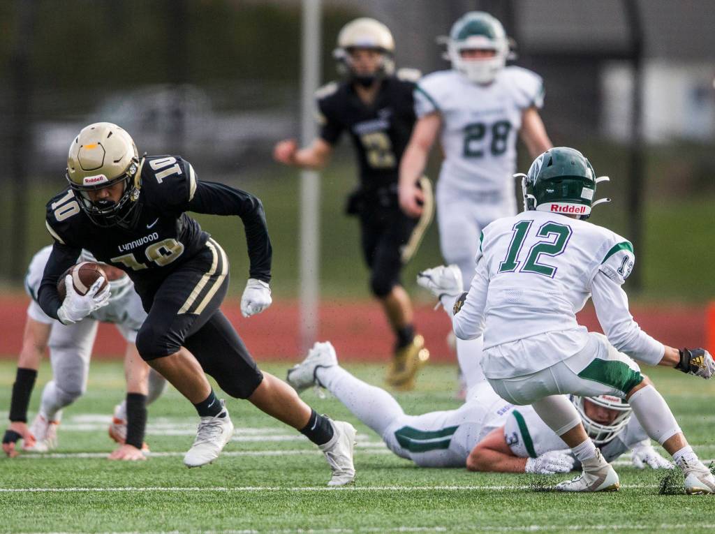 Lynnwoods John Miguel Hurtado runs the ball down the field after escaping multiple tackles during the game on Friday, March 26, 2021 in Edmonds, Wa. (Olivia Vanni / The Herald)