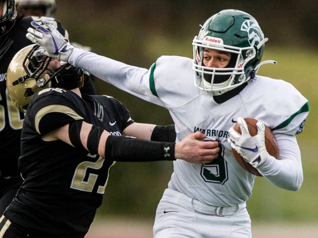 Edmonds-Woodways Steele Swinton stiff arms Lynnwoods Paul Holeman during the game on Friday, March 26, 2021 in Edmonds, Wa. (Olivia Vanni / The Herald)