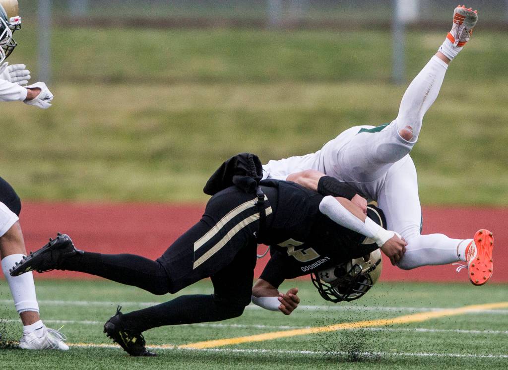 Lynnwoods Deon Baker hits Edmonds-Woodways Charlie Finch during the game on Friday, March 26, 2021 in Edmonds, Wa. (Olivia Vanni / The Herald)
