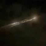In this image taken from video provided by Roman Puzhlyakov, debris from a SpaceX rocket lights up the sky behind clouds over Vancouver, Wash. Thursday evening, March 25, 2021. The remnants of the second stage of the Falcon 9 rocket left comet-like trails as they burned up upon re-entry in the Earth's atmosphere according to a tweet from the National Weather Service. (Roman Puzhlyakov via AP)