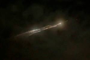 In this image taken from video provided by Roman Puzhlyakov, debris from a SpaceX rocket lights up the sky behind clouds over Vancouver, Wash. Thursday evening, March 25, 2021. The remnants of the second stage of the Falcon 9 rocket left comet-like trails as they burned up upon re-entry in the Earth's atmosphere according to a tweet from the National Weather Service. (Roman Puzhlyakov via AP)
