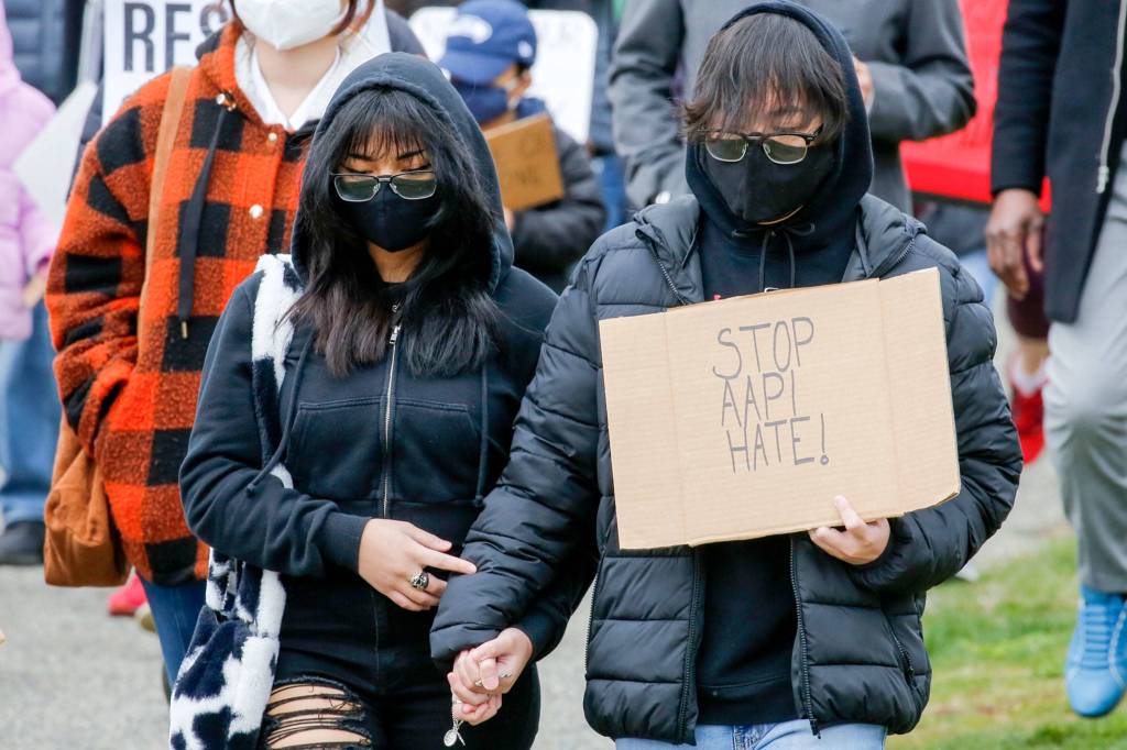 Rally participants silently march in unity and to support Asian and Pacific Islander communities Saturday morning at Esperance Park in Edmonds. (Kevin Clark / The Herald)