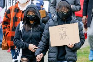 Rally participates silently march for unity support Asian and Pacific Islander communities Saturday morning at Esperance Park in Edmonds on March 27, 2021. (Kevin Clark / The Herald)