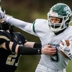 Edmonds-Woodway's Steele Swinton stiff arms Lynnwood's Paul Holeman during the game on Friday, March 26, 2021 in Edmonds, Wa. (Olivia Vanni / The Herald)