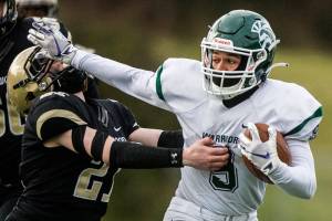 Edmonds-Woodway's Steele Swinton stiff arms Lynnwood's Paul Holeman during the game on Friday, March 26, 2021 in Edmonds, Wa. (Olivia Vanni / The Herald)