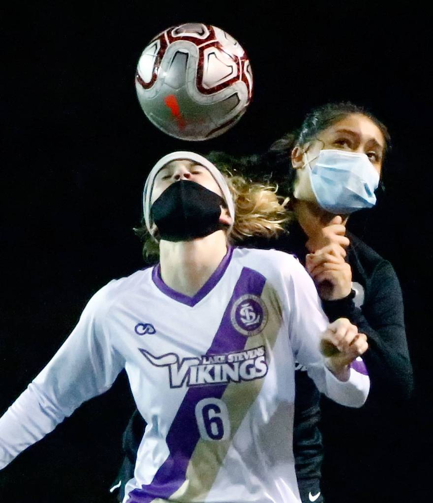 Lake Stevens Delaine Polly heads the ball with Jacksons Maki Quiyono behind her during a March 18 game at Everett Memorial Stadium. (Kevin Clark / The Herald)