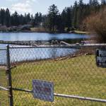 A person fishes off a dock at Thornton A. Sullivan Park that boarders the private because along West Ibberson Drive on Wednesday, March 10, 2021 in Everett, Wa. (Olivia Vanni / The Herald)