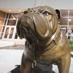Fans pass a bulldog statue, the team's mascot, on their way to the entrance at the McCarthey Athletic Center on the Gonzaga University campus before an NCAA college basketball game against Texas Southern in Spokane, Wash., Monday, Dec. 15, 2014. (AP Photo/Young Kwak)