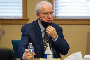 Simeon Berkley pulls up his mask after taking a drink of water before the start of his trial at the Snohomish County Courthouse on Friday, April 2, 2021 in Everett, Wa. (Olivia Vanni / The Herald)