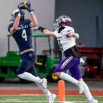 Glacier Peaks Cooper Jensen makes a touchdown reception against Lake Stevens Alexander Davis Thursday night at Veterans Memorial Stadium in Snohomish on April 1, 2021. (Kevin Clark / The Herald)
