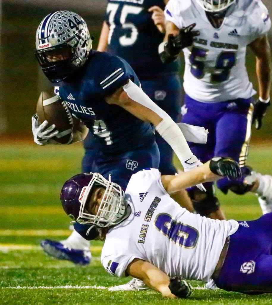 Glacier Peaks Trevor Meldrom rushes for yardage Thursday night at Veterans Memorial Stadium in Snohomish on April 1, 2021. (Kevin Clark / The Herald)