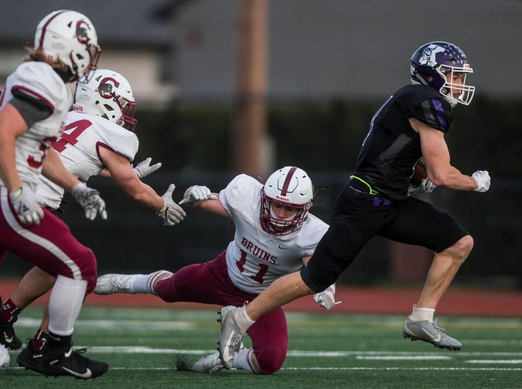 Kamiaks Wesley Garrett (right) runs the ball during a game against Cascade on April 1, 2021, in Everett. (Olivia Vanni / The Herald)