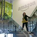 FILE - In this Sept. 27, 2017, file photo, an Amazon worker walks down steps in a company office before an event announcing several new Amazon products by the company in Seattle. Amazon plans to have its employees return to the office by fall as the tech giant transitions away from the remote work it implemented for many workers due to the coronavirus pandemic. On Tuesday, March 30, 2021, the company told employees it is planning a "return to an office-centric culture as our baseline." (AP Photo/Elaine Thompson, File)