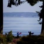 Dongyue Zhuang and Hong Li do tai chi fan at Harborview Park on Tuesday in Everett. (Olivia Vanni / The Herald)