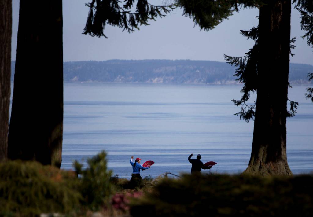 Dongyue Zhuang and Hong Li do tai chi fan at Harborview Park on Tuesday in Everett. (Olivia Vanni / The Herald)
