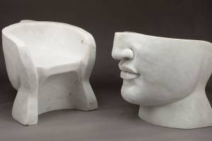 The marble chair is cold and hard but is not meant to have cushions. It is so deep that a short woman's feet will not touch the floor. (Cowles Syndicate Inc.)