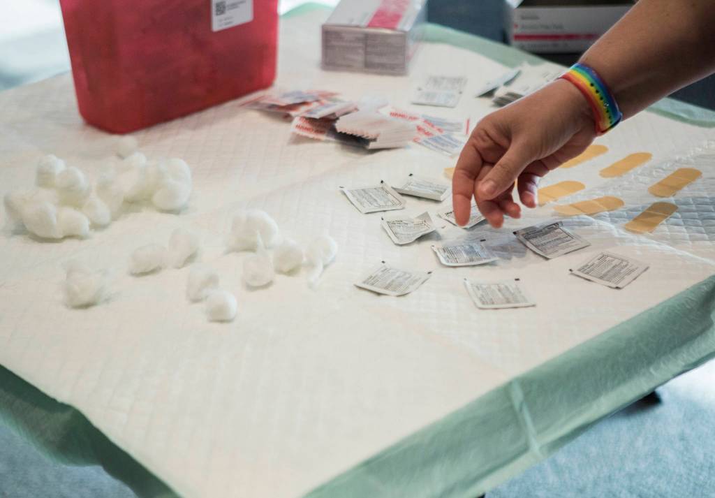 A vaccination station is prepared at Angel of the Winds Arena in Everett on Tuesday. (Olivia Vanni / The Herald)