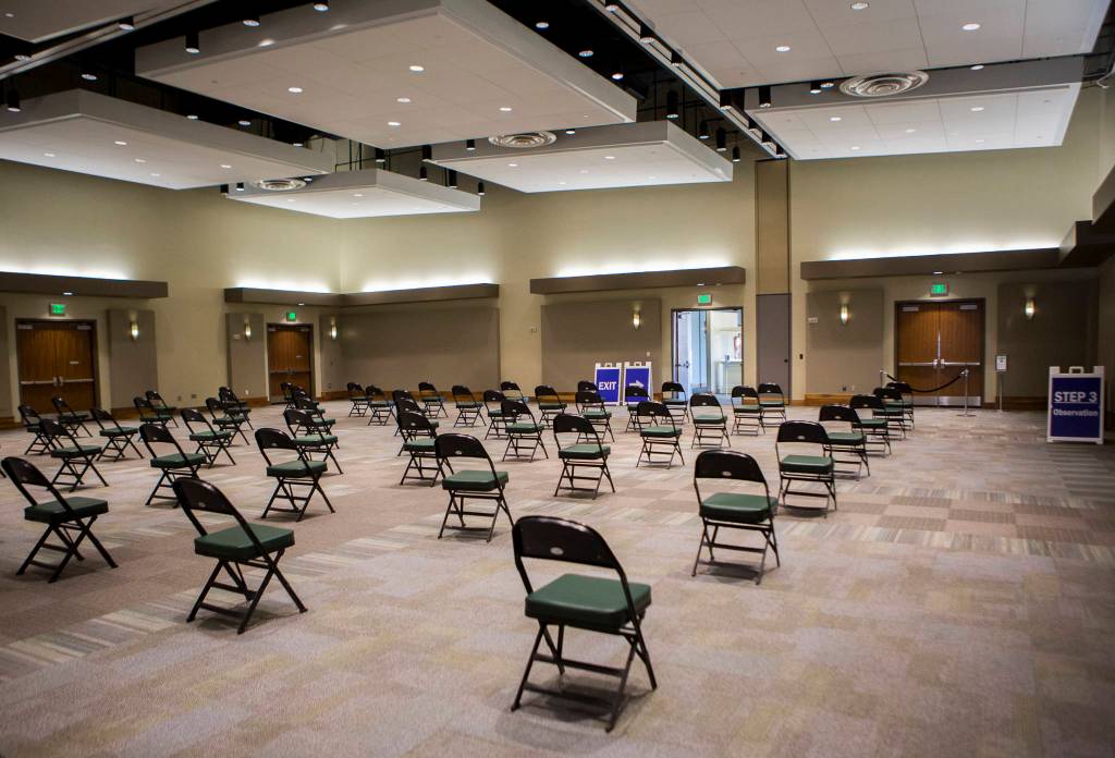 The waiting area for people who have received vaccinations at Angel of the Winds Arena in Everett. Recipients must wait 15 minutes to ensure there are no immediate side effects. (Olivia Vanni / The Herald)