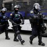 Washington State Patrol troopers walk off of a bus in front of Seattle City Hall as they prepare for demonstrators to arrive Wednesday, June 3, 2020, in Seattle, following protests over the death of George Floyd, a black man who was in police custody in Minneapolis. (AP Photo/Elaine Thompson)