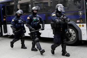 Washington State Patrol troopers walk off of a bus in front of Seattle City Hall as they prepare for demonstrators to arrive Wednesday, June 3, 2020, in Seattle, following protests over the death of George Floyd, a black man who was in police custody in Minneapolis. (AP Photo/Elaine Thompson)
