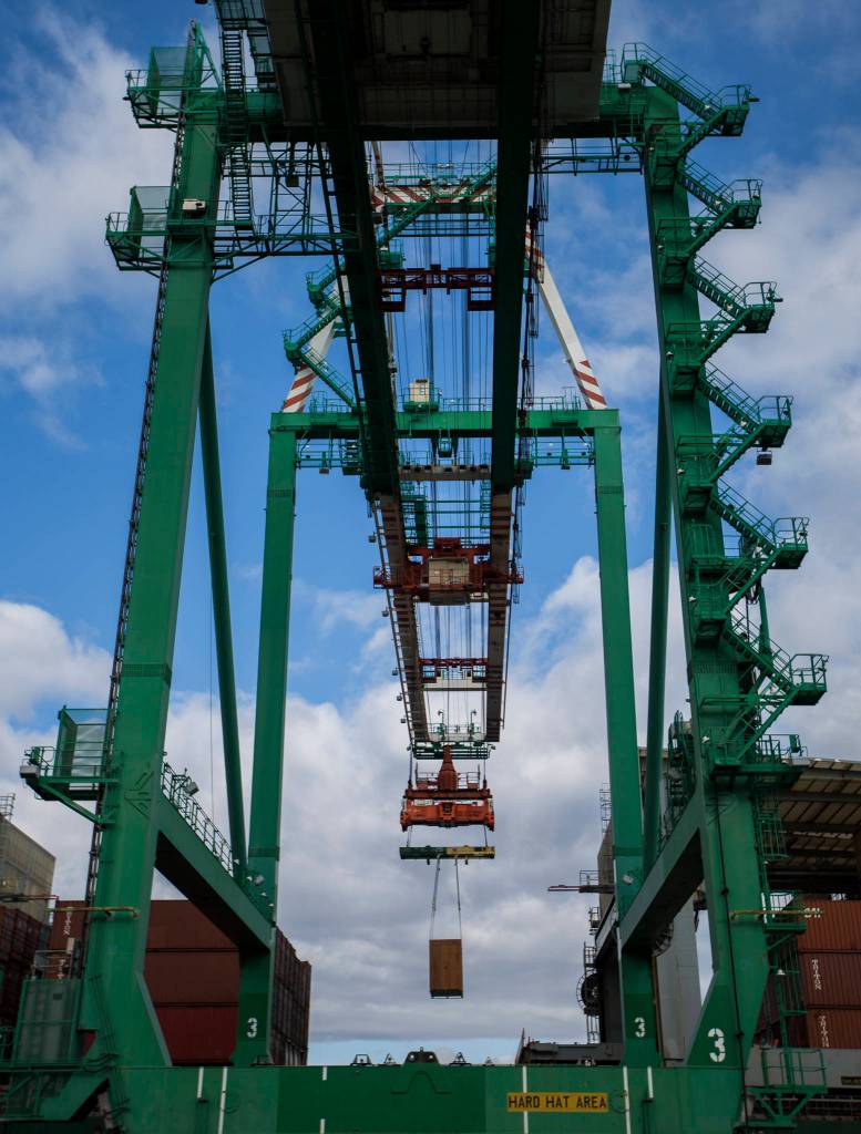 Cargo is offloaded from Westwood Columbia, a 655-foot ship carrying aerospace components, consumer goods and industrial equipment, at South Terminal of the Port of Everett on Thursday. (Olivia Vanni / The Herald)
