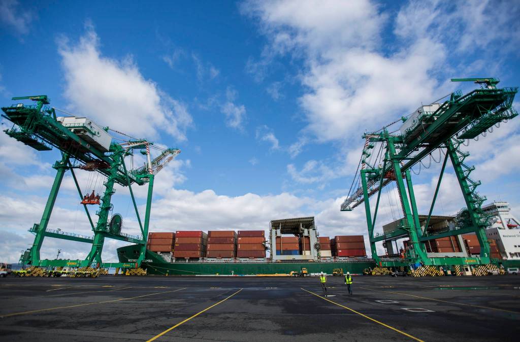 One of two cranes works to offload cargo at the South Terminal of the Port of Everett on Thursday. (Olivia Vanni / The Herald)