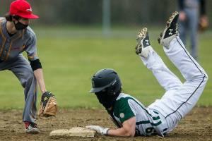 Marysville Getchell's Bradley Aasen slides into second base while Marysville Pilchuck's Alex Smith reaches to tag him during the game on Wednesday, April 7, 2021 in Marysville, Wa. (Olivia Vanni / The Herald)