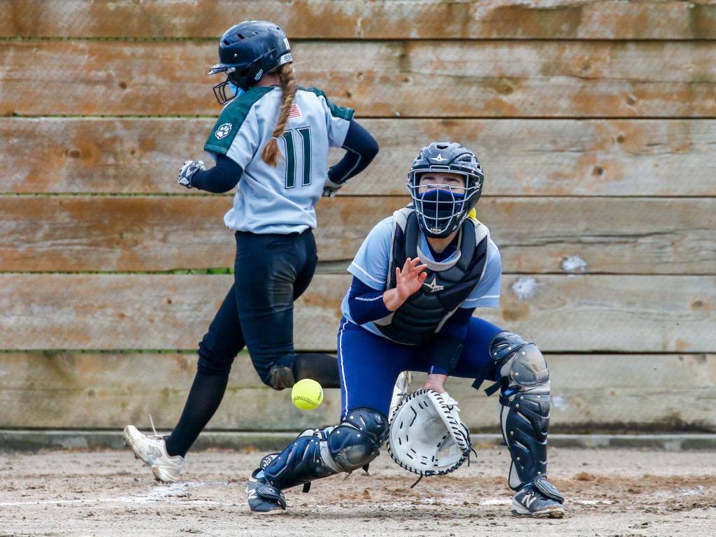 Jacksons Rachel Sysum beats the throw home to Everetts Kayla Flores for a run Thursday afternoon at Henry M. Jackson High School in Mill Creek on April 8, 2021. Jackson dominated Everett, 14-0. (Kevin Clark / The Herald)