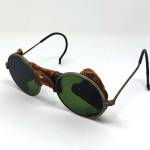 This is a very early pair of glasses with tinted lenses not used as sunglasses. (Cowles Syndicate Inc.)