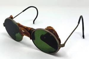 This is a very early pair of glasses with tinted lenses not used as sunglasses. (Cowles Syndicate Inc.)