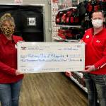 Beth Kealy, President of the Rotary Club of Edmonds accepts a check from Chris Kyser, store director of Edmonds Hero Ace Hardware.