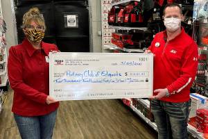 Beth Kealy, President of the Rotary Club of Edmonds accepts a check from Chris Kyser, store director of Edmonds Hero Ace Hardware.