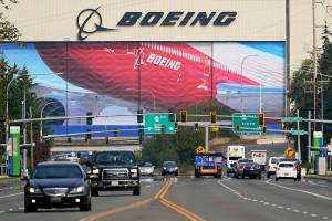 FILE - In this Oct. 1, 2020 file photo, traffic passes the Boeing airplane production plant, in Everett, Wash.  U.S. manufacturers expanded in March 2021 at the fastest pace in 37 years, a sign of strengthening demand as the pandemic wanes and government emergency aid flows through the economy.  (AP Photo/Elaine Thompson, file)