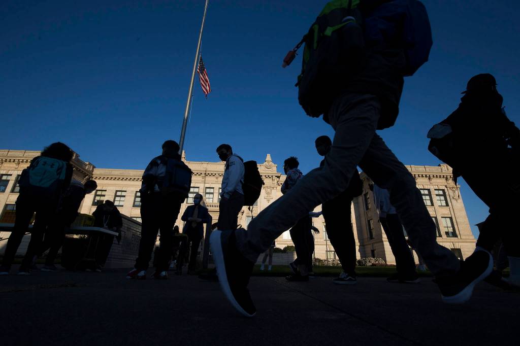 Students arrive for the first day of in-person school at Everett High on Monday. (Andy Bronson / The Herald)