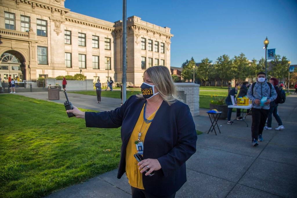 First-year principal Amanda Overly directs students before the start of the first day of in-person school at Everett High on Monday. (Andy Bronson / The Herald)