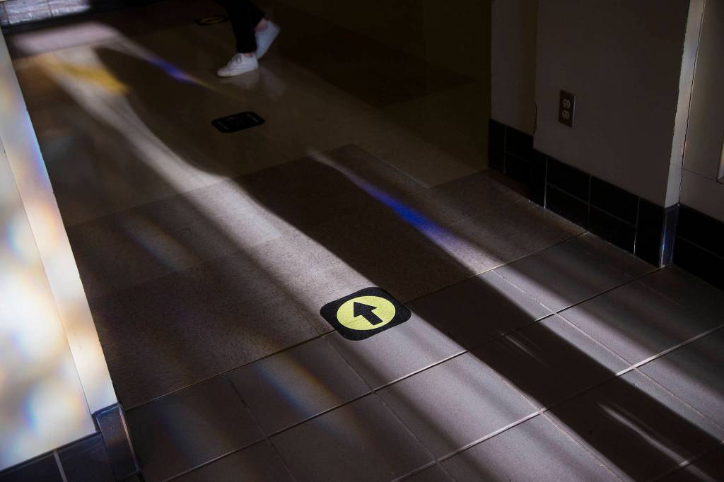 Arrows direct students through the hallways on Monday at Everett High as students attend classes in person for the first time this year. (Andy Bronson / The Herald)