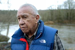 FILE - In this Jan. 13, 2014, file photo, Billy Frank Jr. poses for a photo near Frank's Landing on the Nisqually River in Nisqually, Wash. Gov. Jay Inslee on Wednesday, April 14, 2021, signed a measure that starts the process of honoring the late Frank, a Nisqually tribal member who championed treaty rights and protecting the environment, with a statue at the U.S. Capitol. (AP Photo/Ted S. Warren, File)