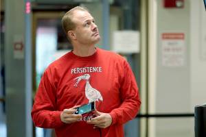 Initiative promoter Tim Eyman looks up at a video monitor in a hallway as he arrives for a session of Thurston County Superior Court, Wednesday, Feb. 10, 2021, in Olympia, Wash. Eyman, who ran initiative campaigns across Washington for decades, will no longer be allowed to have any financial control over political committees, under a ruling from Superior Court Judge James Dixon Wednesday that blasted Eyman for using donor's contributions to line his own pocket. Eyman was also told to pay more than $2.5 million in penalties. (AP Photo/Ted S. Warren)