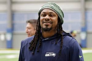 FILE - Seattle Seahawks running back Marshawn Lynch walks off the field after NFL football practice in Renton, Wash., in this Friday, Dec. 27, 2019, file photo. During Marshawn Lynch’s 12 NFL seasons he earned a reputation for his fearless style on the field, while remaining one of the league’s most reclusive figures off the field. Now the retired running back is lending his voice to try to help members of Black and Hispanic communities make more informed decisions about receiving COVID-19 vaccines. Lynch released a 30-minute interview with Dr. Anthony Fauci on his YouTube channel Friday, April 16, 2021, becoming the latest prominent athlete to sit down with him to discuss the efficacy of COVID-19 vaccines as the U.S. continues to combat the pandemic.  (AP Photo/Ted S. Warren, File)