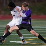 Meadowdales Mark Dormoh (left) steals the ball from Kamiaks Cade Weatherbie during a game on April 16, 2021, in Mukilteo. (Olivia Vanni / The Herald)