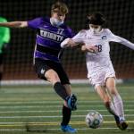 Meadowdales Theo Uherka Hartman (right) and Kamiaks Zach Johnson go after the ball during a game on April 16, 2021, in Mukilteo. (Olivia Vanni / The Herald)