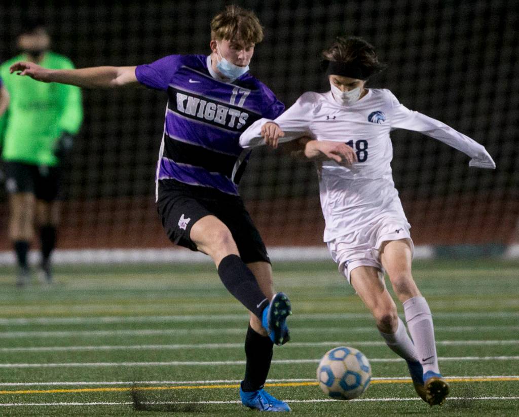 Meadowdales Theo Uherka Hartman (right) and Kamiaks Zach Johnson go after the ball during a game on April 16, 2021, in Mukilteo. (Olivia Vanni / The Herald)